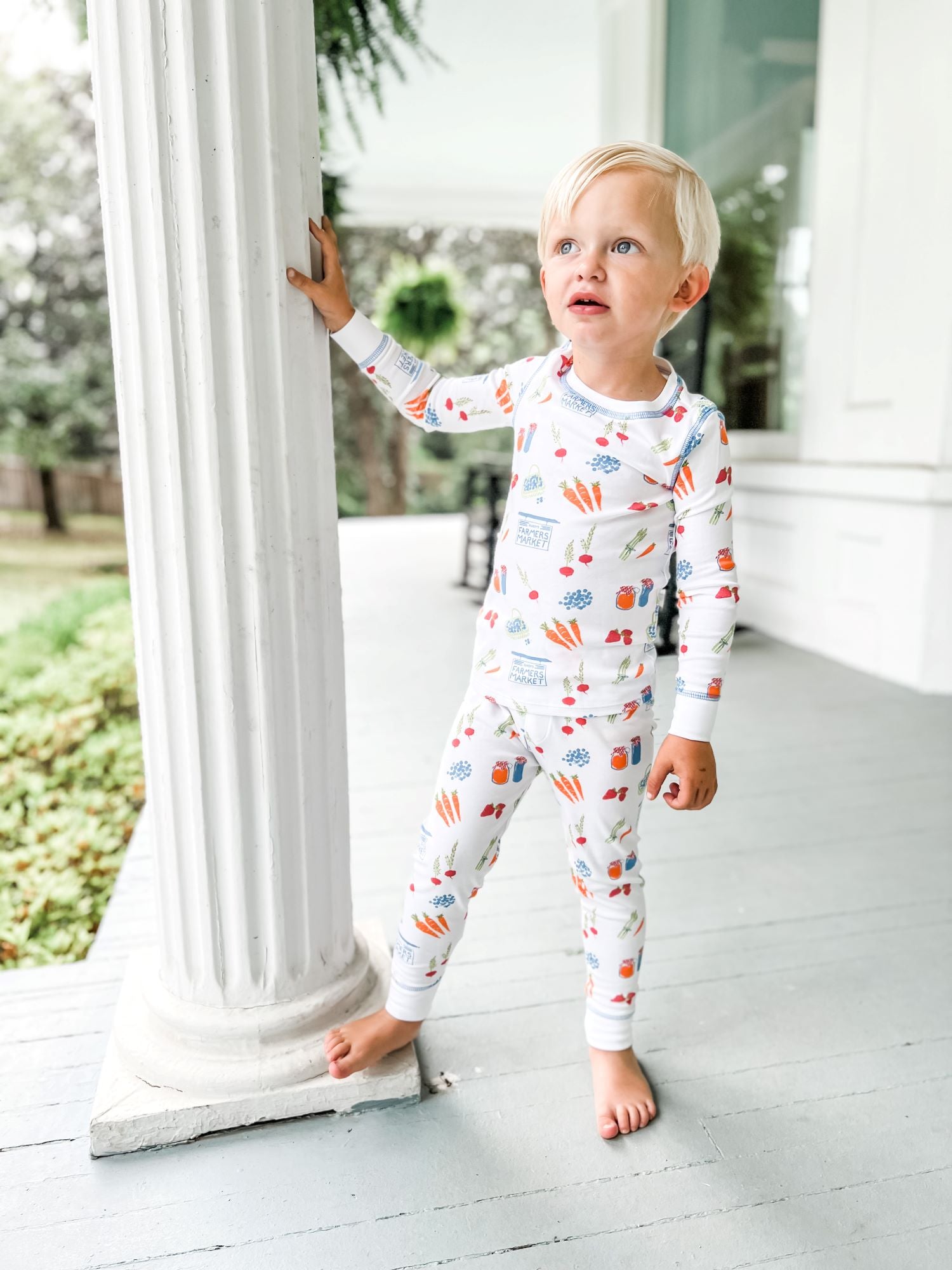 Little Boy Wearing Heyward House Farmer's Market Pajama Set Outside