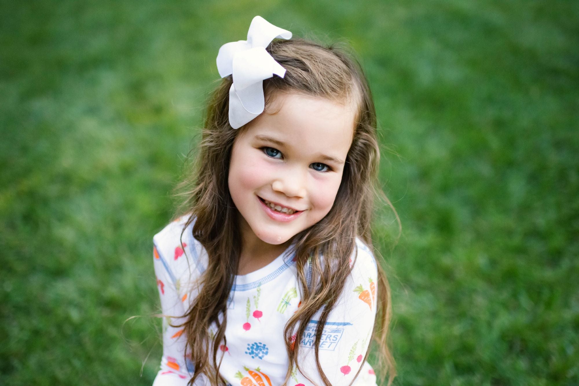 Little Girl Wearing Heyward House Farmer's Market Pajama Set Outside