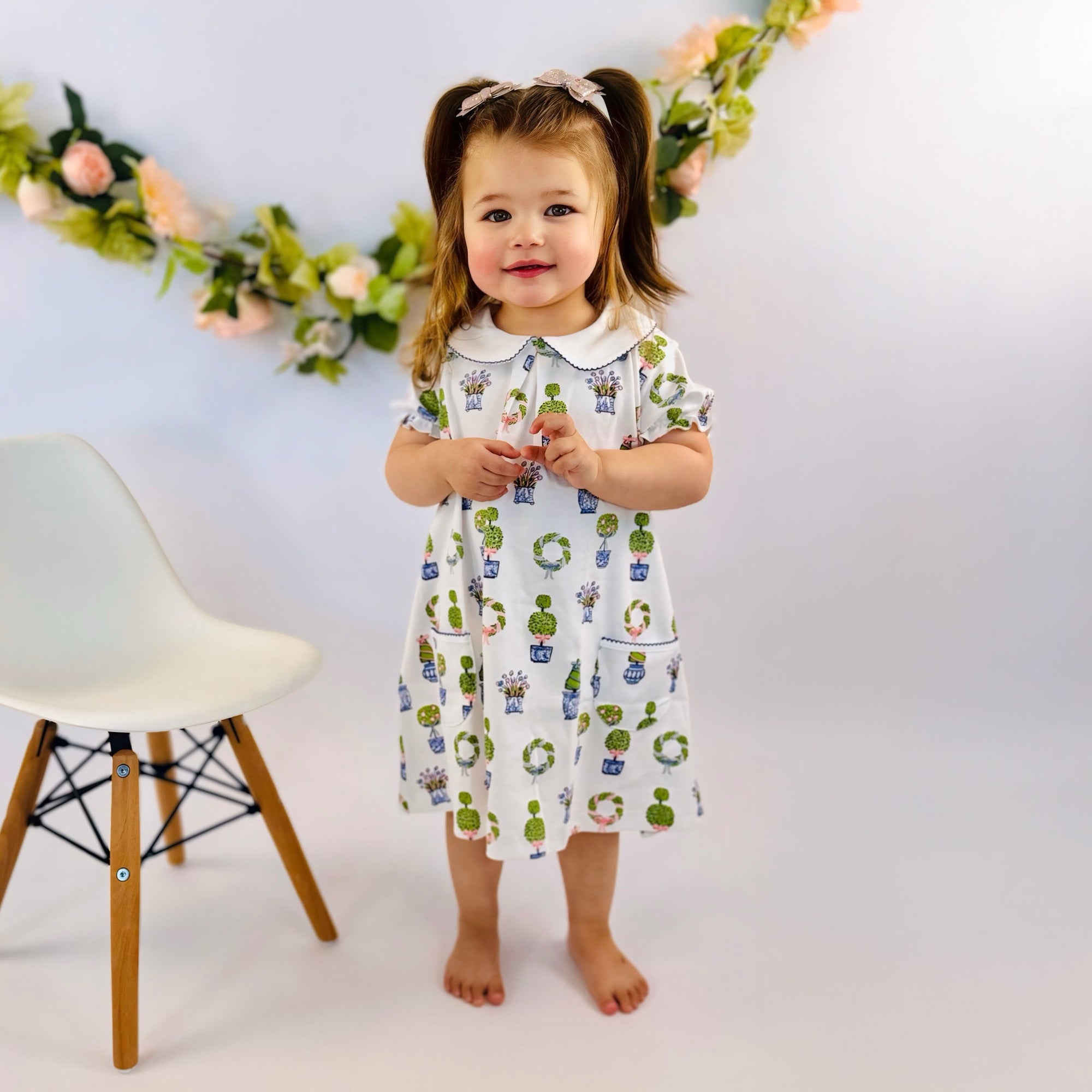 Adorable little girl in floral print dress by Heyward House.