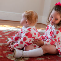 Sisters playing in Heyward House Pink Dog Pattern Pocket Twirl Dress