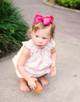 Little girl in Pink Pram Heyward House Smocked Dress