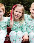 Little Children wearing Mint green two-piece pajama set with vintage Christmas reindeer pattern made with pima cotton
