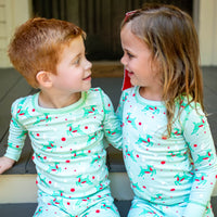 Little Children wearing Mint green two-piece pajama set with vintage Christmas reindeer pattern made with pima cotton