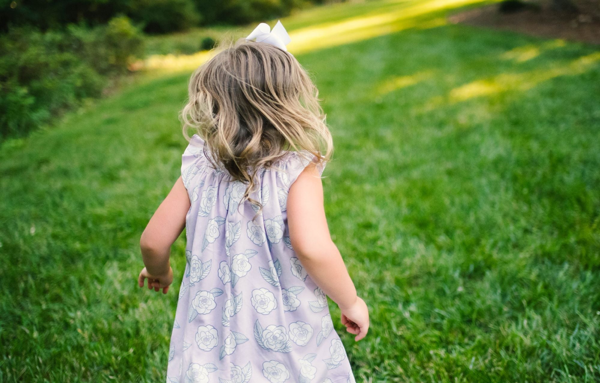 Little Girl playing in Heyward House Camellia Smocked Dress