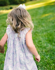 Little Girl playing in Heyward House Camellia Smocked Dress