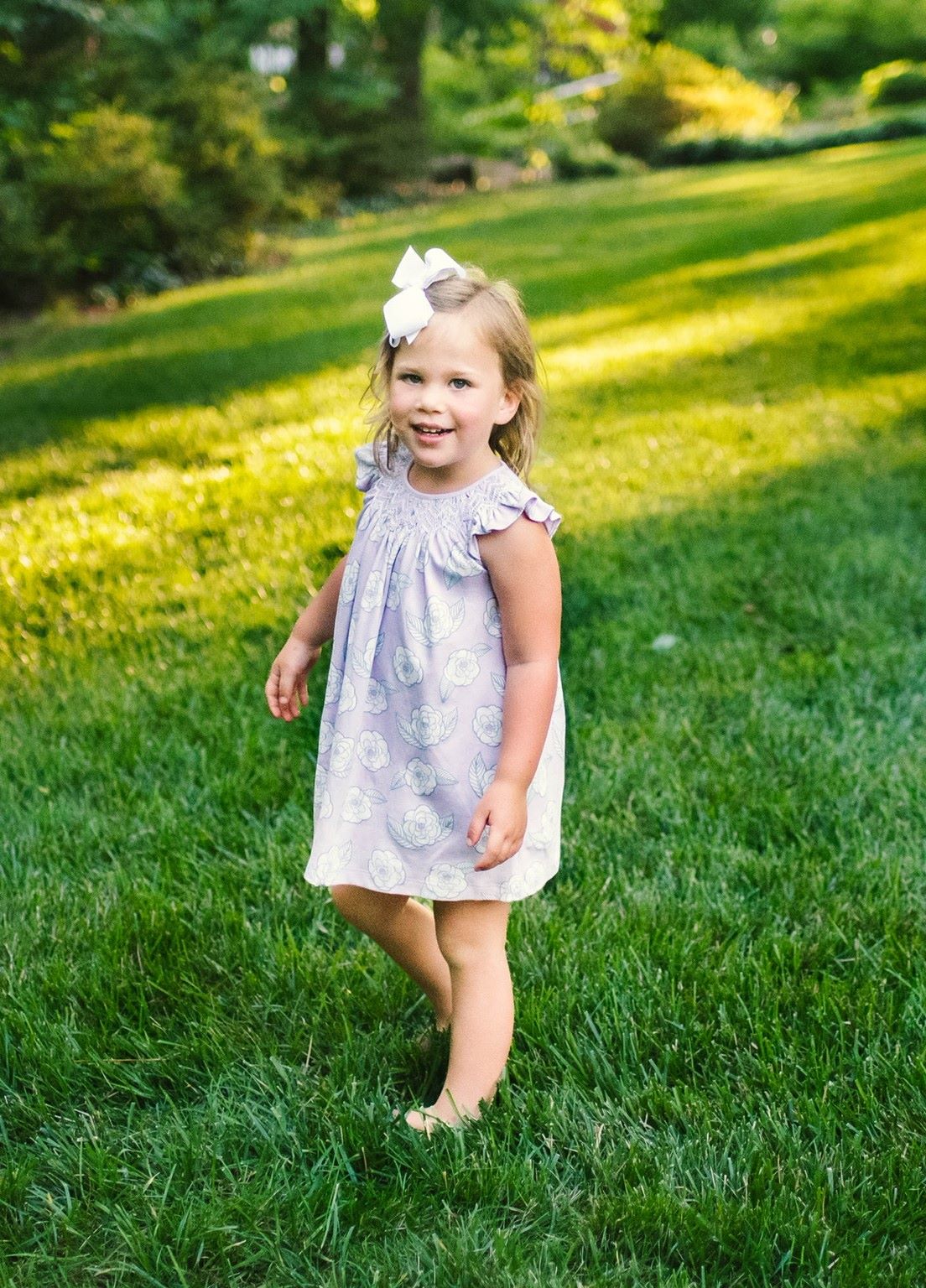 Little Girl playing in Heyward House Camellia Smocked Dress