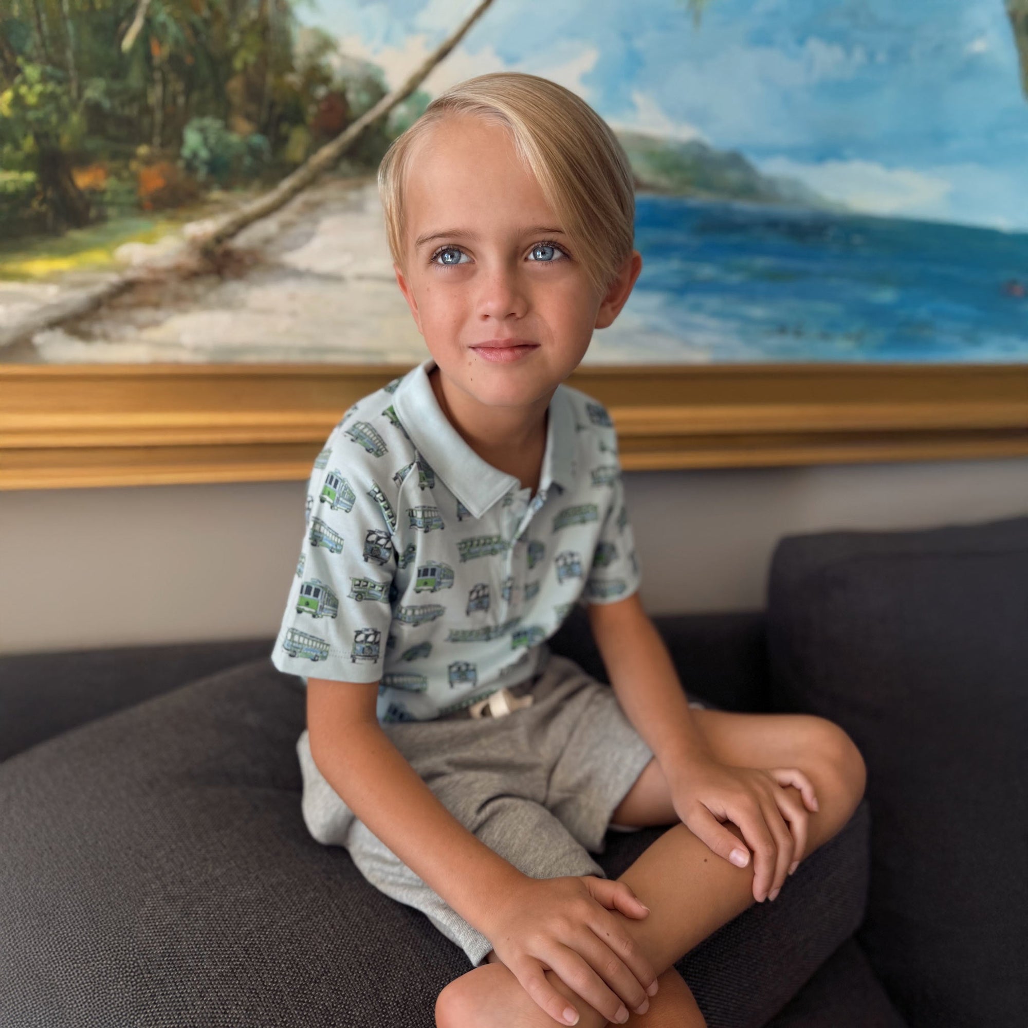 Cute little boy wearing a blue and green trolley polo