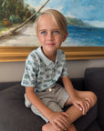 Cute little boy wearing a blue and green trolley polo