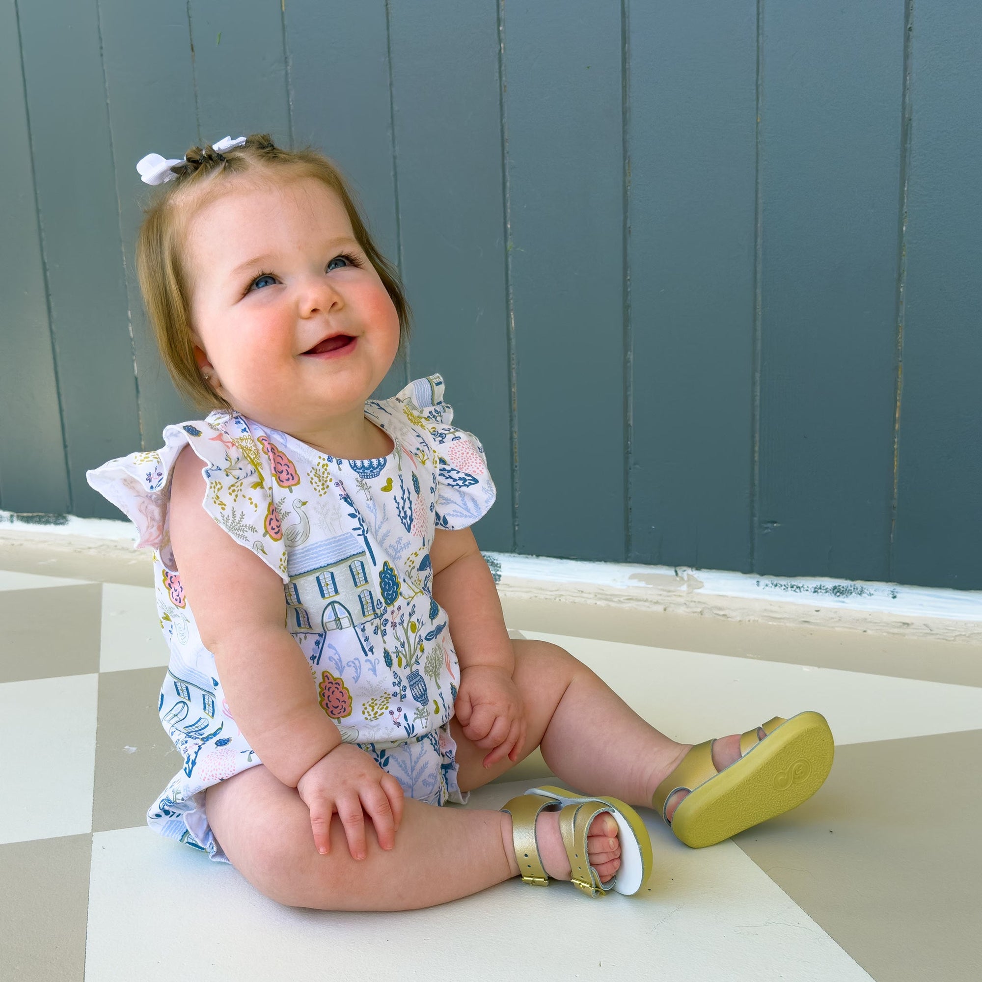 Cute smiling baby wearing English Countryside bubble