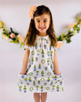 Young girl in floral printed topiary dress for spring.