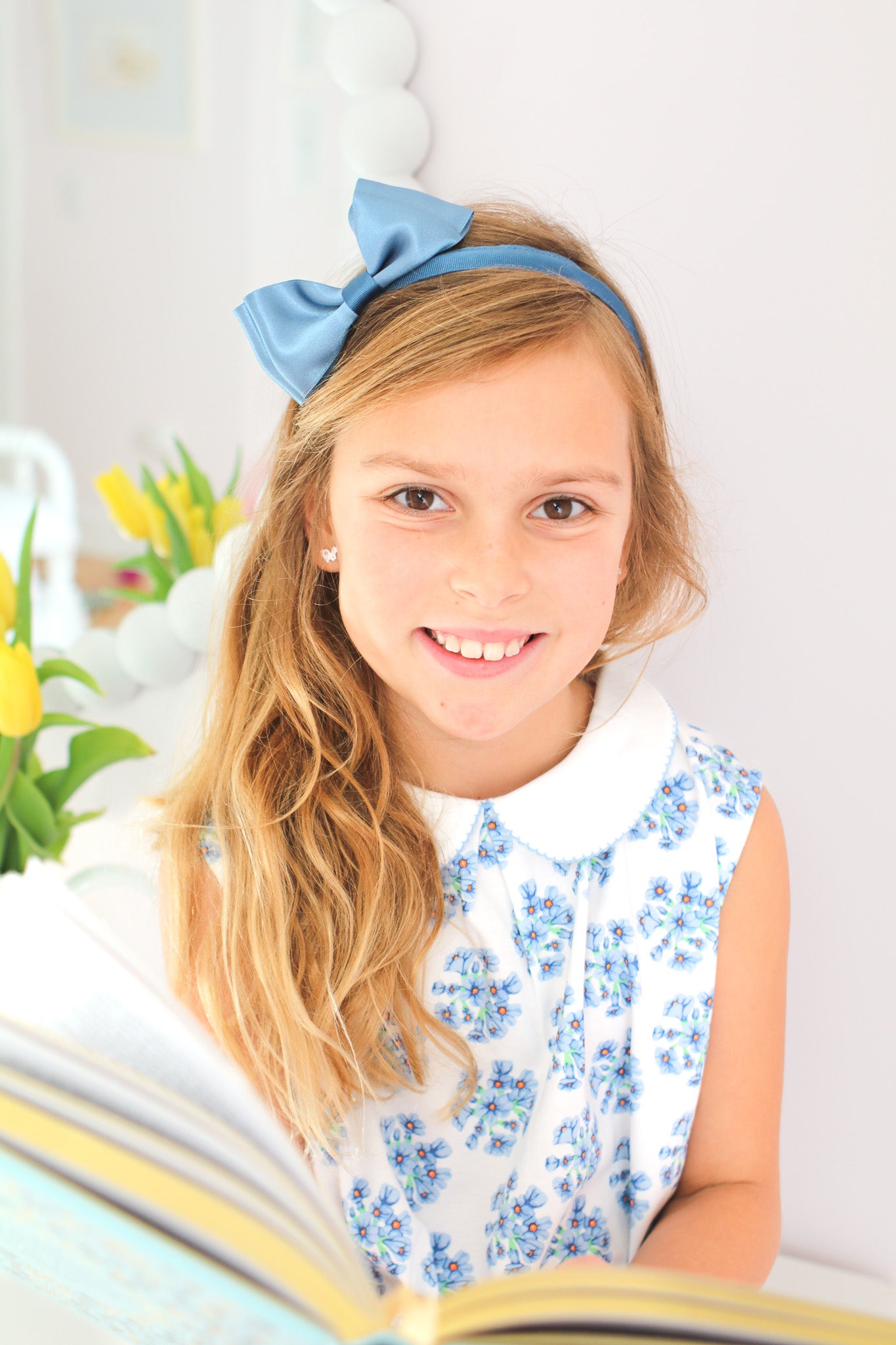 Smiling girl wearing blue flower twirl dress