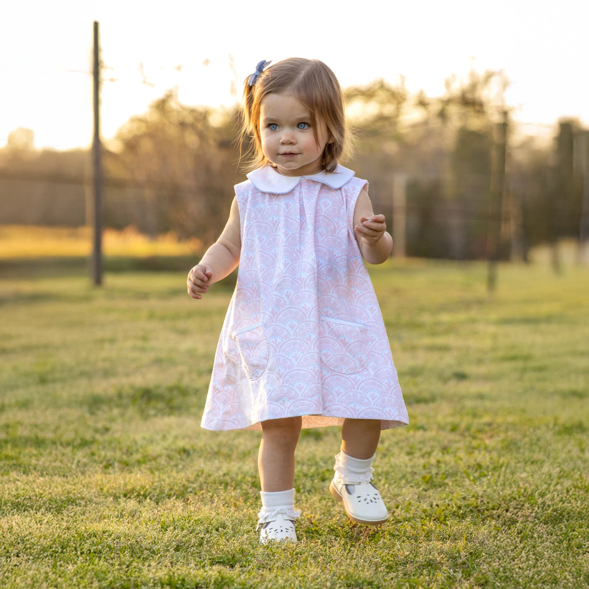 Toddler in Heyward House pima pink and white sleeveless dress