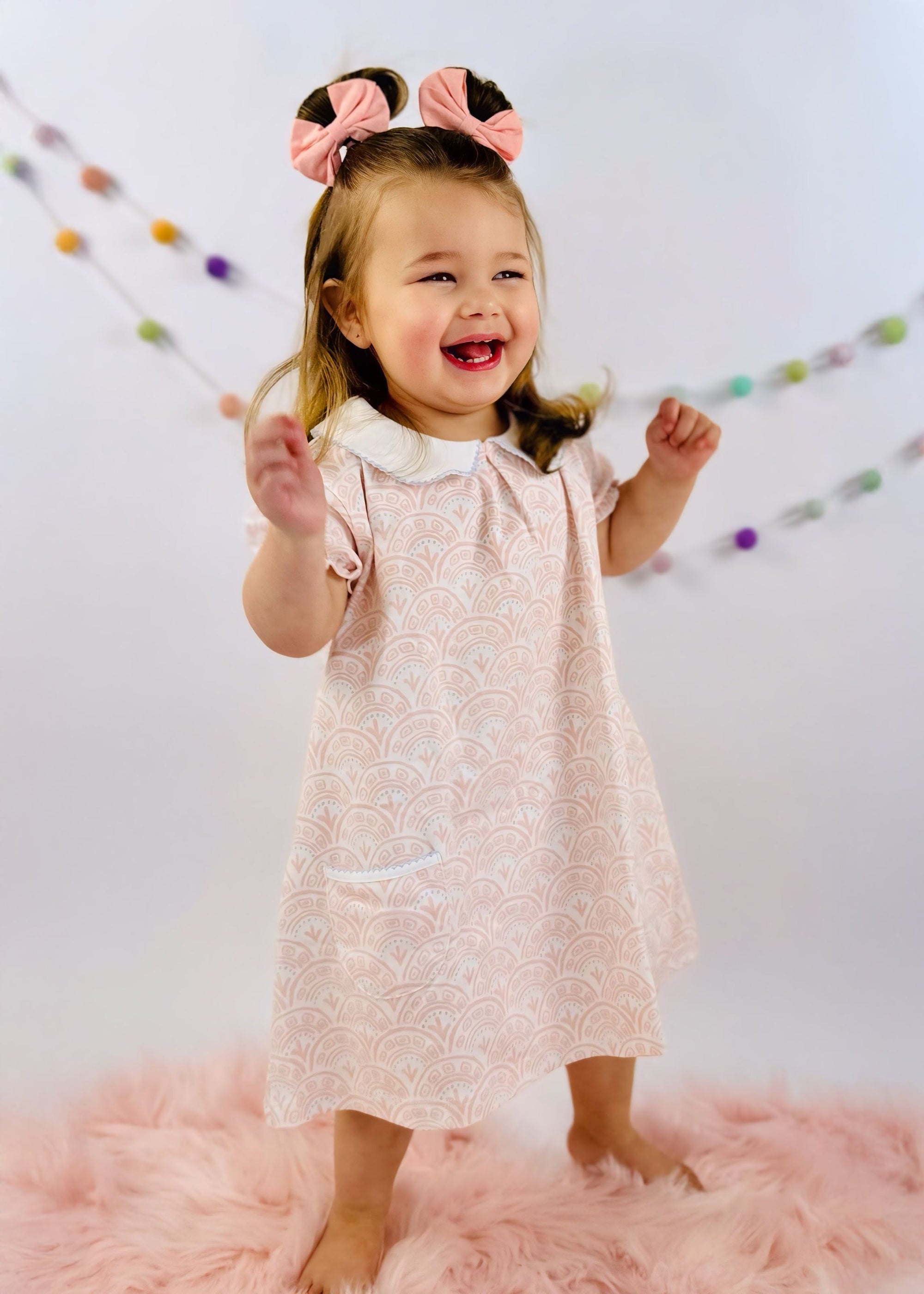 Cute little girl in Pink Scallop ss pocket twirl dress by Heyward House.