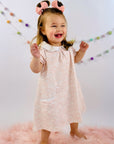 Cute little girl in Pink Scallop ss pocket twirl dress by Heyward House.