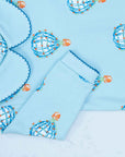 Close-up of Light blue boys playsuit with classic peter-pan collar and hot air balloon pattern made in pima cotton - back view