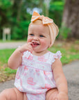 cute baby girl wearing smocked bubble with vintage pram pattern