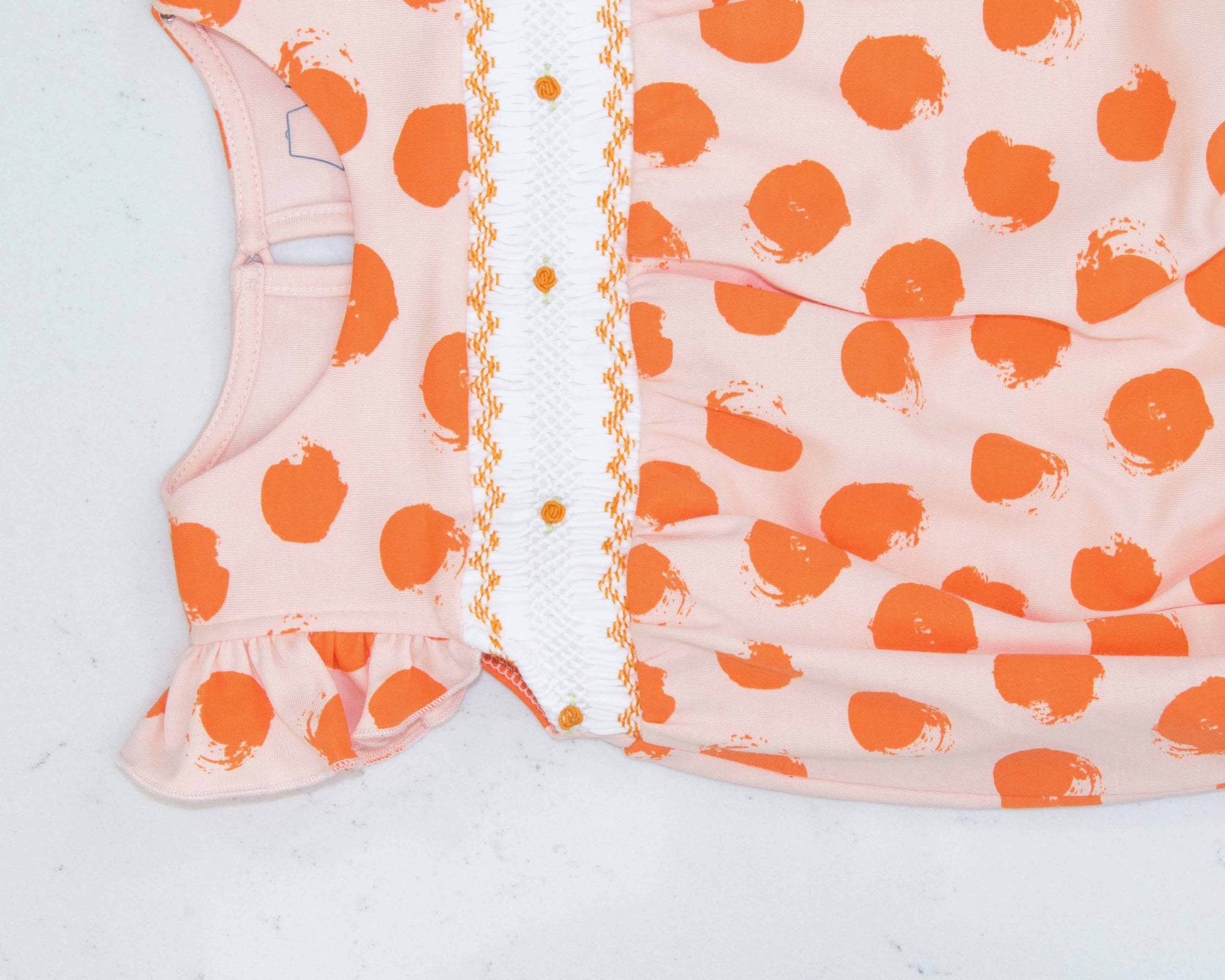 detailed view pink girls bubble with smock and orange dots pattern made in pima cotton