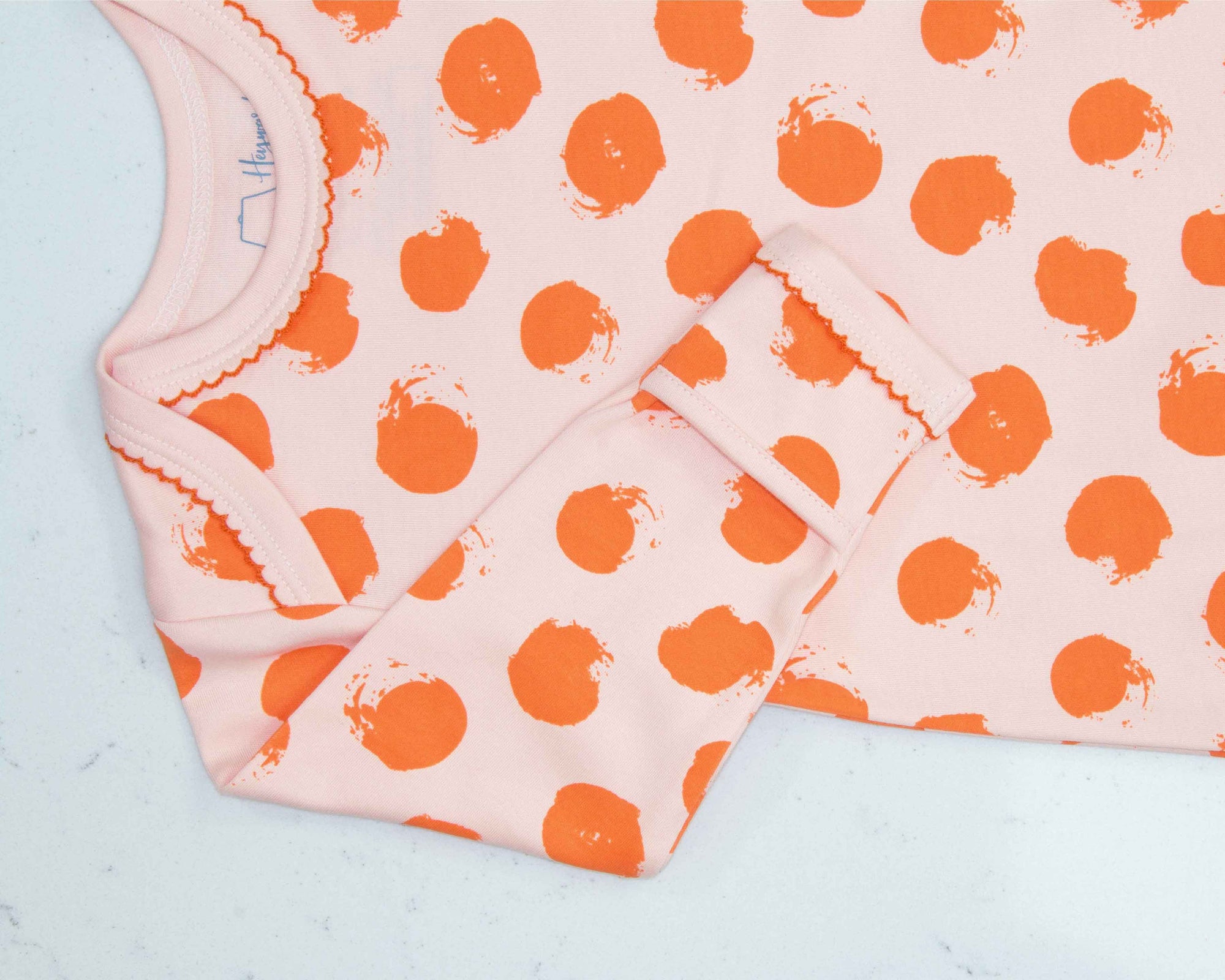 Pink gown with orange polka dot pattern with scratch preventer detail view