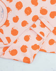 Pink gown with orange polka dot pattern with scratch preventer detail view