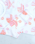 White infant gown with pink baby carriage pram pattern with scratch guard detail