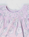 detailed view pink girls dress with smock and camellia flower pattern made in pima cotton
