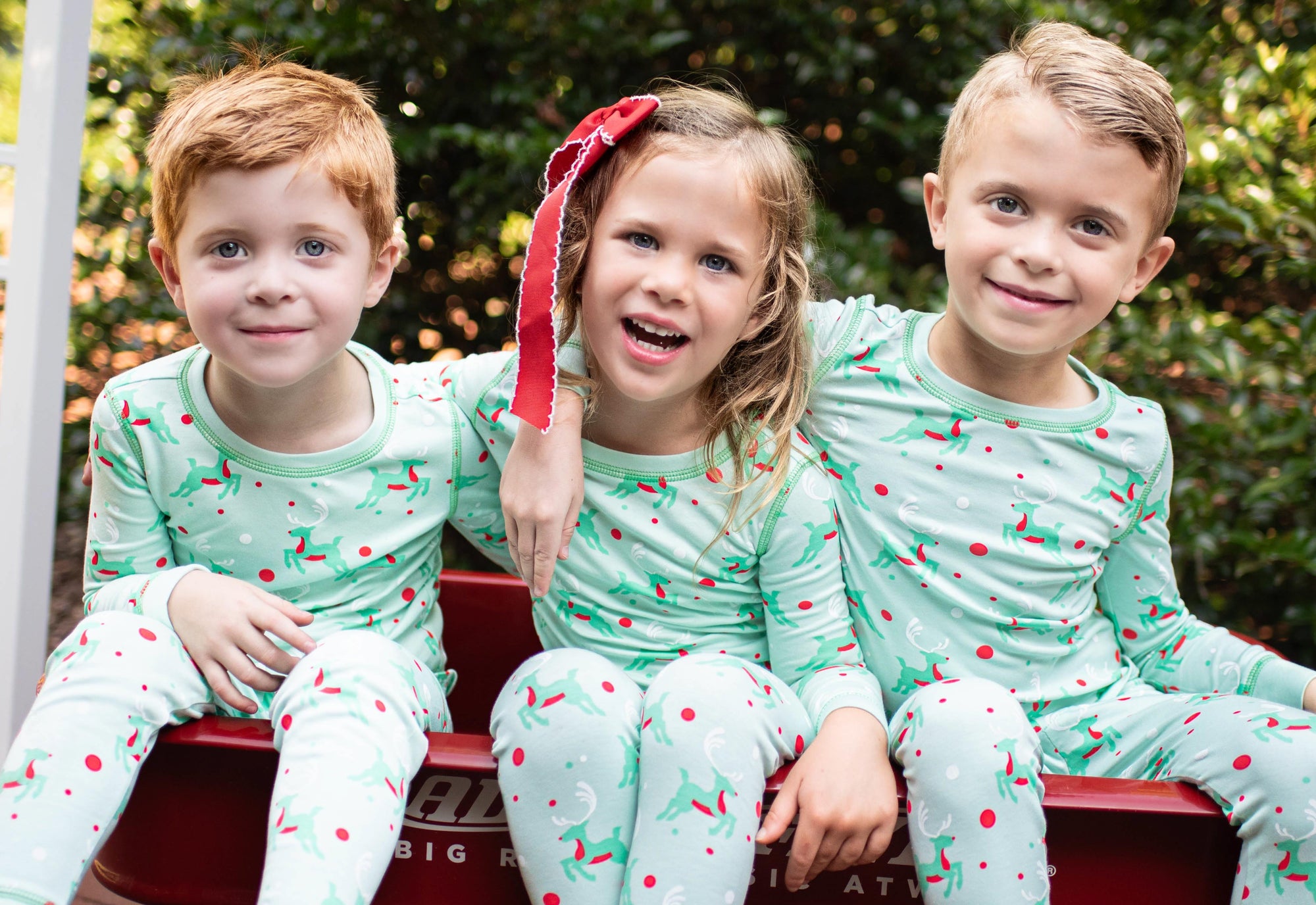Little kids wearing retro reindeer Christmas pajamas from the Heyward House 2023 Fall collection