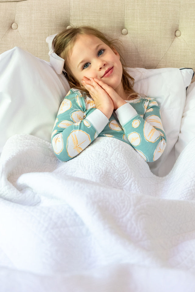 little girl wearing heyward house pajamas pretending to sleep