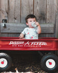Little Boy in Wagon wearing Heyward House Short Sleeve Equestrian Playtime Romper