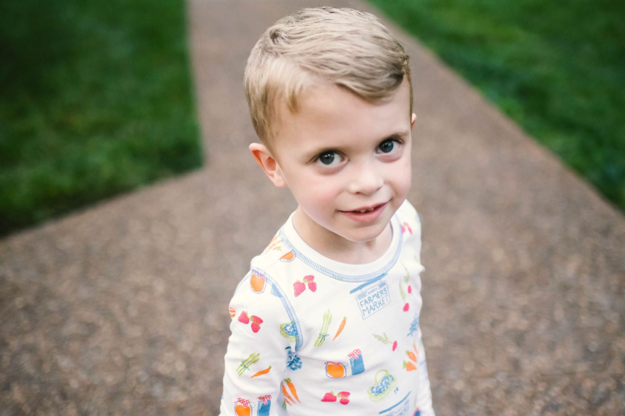 Little Boy Wearing Heyward House Farmer&#39;s Market Pajama Set Outside with Details
