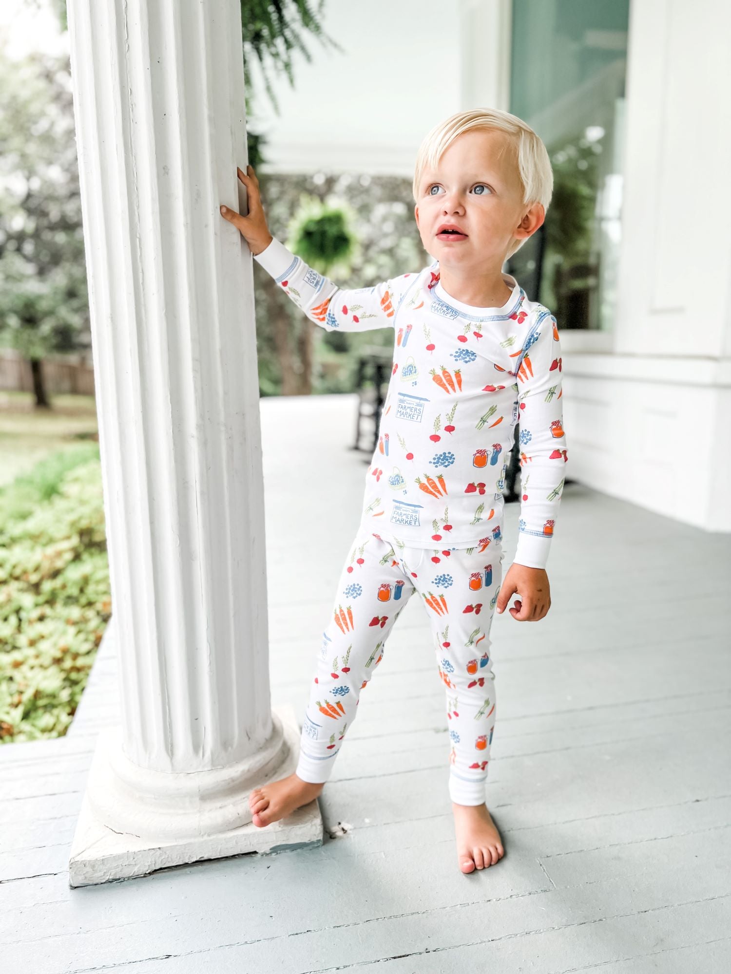 Little Boy Wearing Heyward House Farmer&#39;s Market Pajama Set Outside