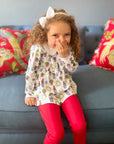 elegant topiary dress set for girls on a smiling little girl sitting down