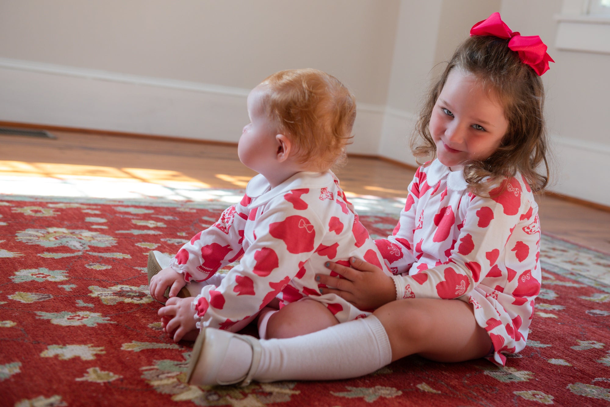 Sisters playing in Heyward House Pink Dog Long Sleeved Bubble
