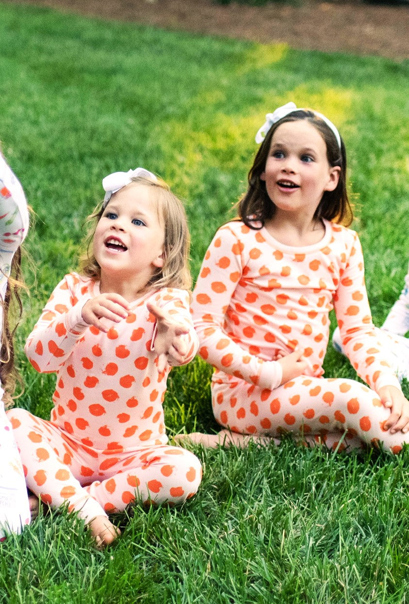 Sisters Playing outside in Heyward House Pink and Orange Polka Dot Pajamas