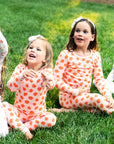 Sisters Playing outside in Heyward House Pink and Orange Polka Dot Pajamas