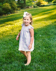 Little Girl playing in Heyward House Camellia Smocked Dress