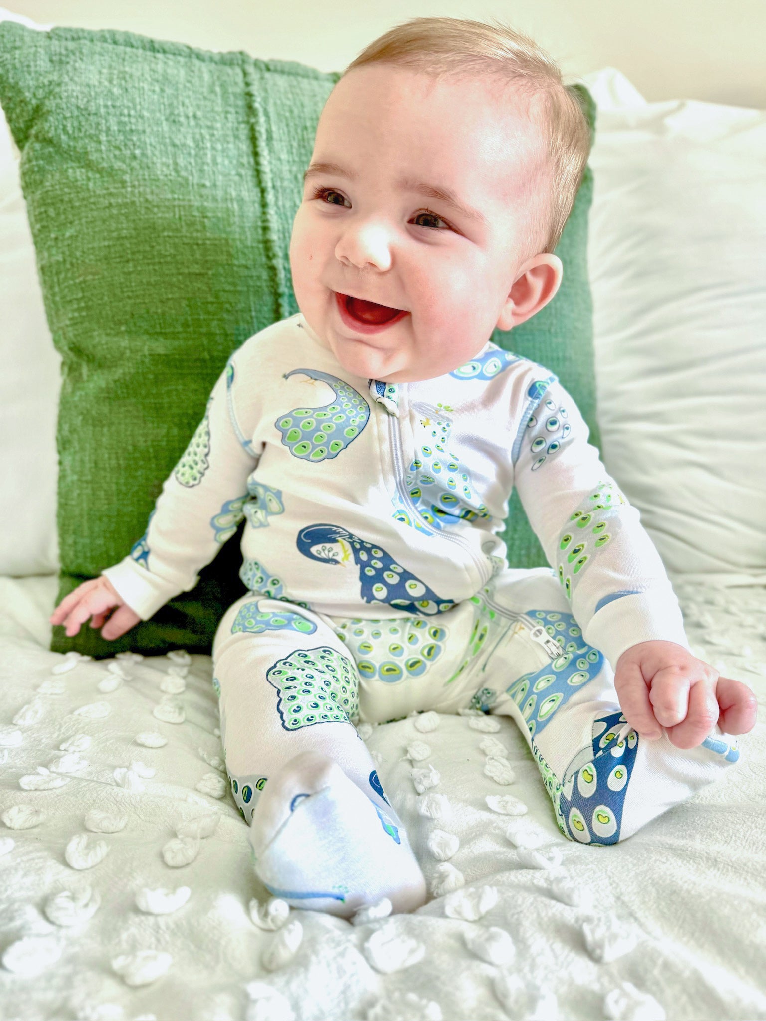 baby in pima pajamas with peacock print by heyward house
