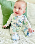 baby in pima pajamas with peacock print by heyward house
