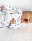 yawning baby in infant gown with blue safari print by Heyward House