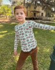 boy leaning away from streetlight in trolley shirt square