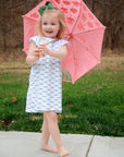 cute little girl wearing dragonflies print holding an umbrella 