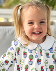 cute smiling girl wearing christmas topiary dress