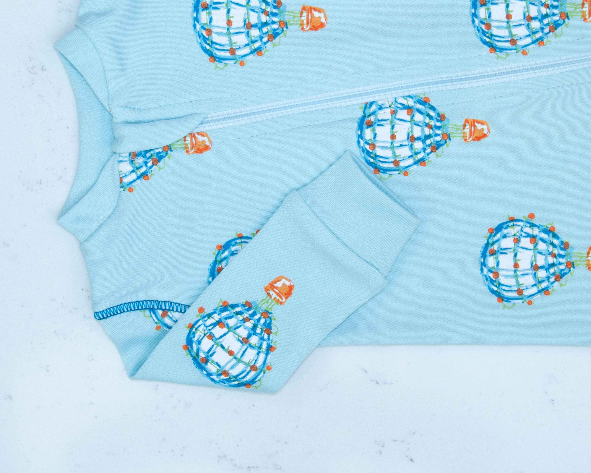 Detail of zipper area of Light blue footed pajama with hot air balloon pattern made in pima cotton
