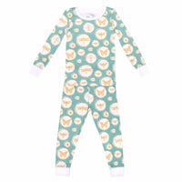 Green and gold two-piece pajama set with bug and insect pattern made with pima cotton