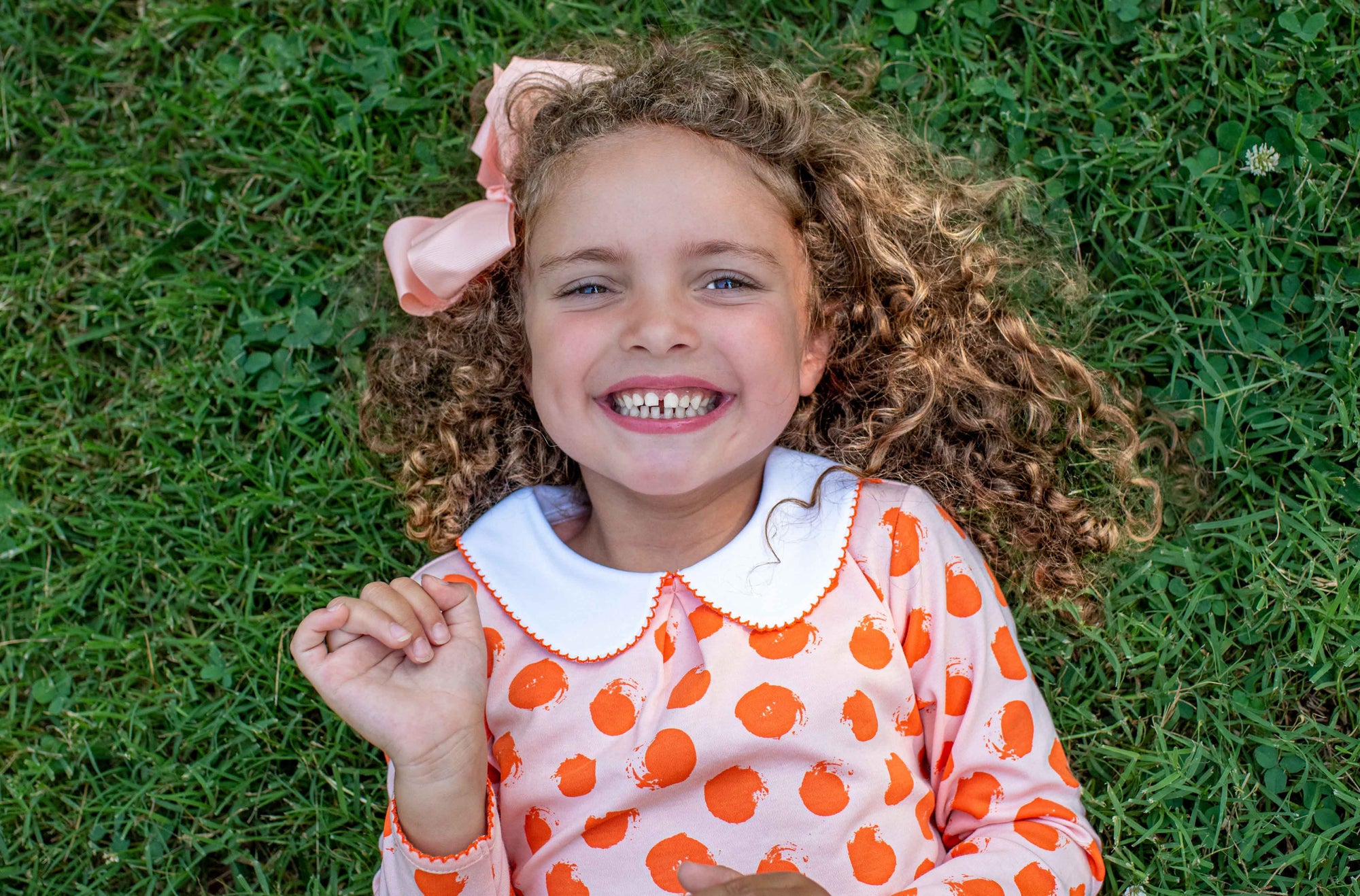 Little Girl in Heyward House Orange Polka Dot Pocket Twirl Dress