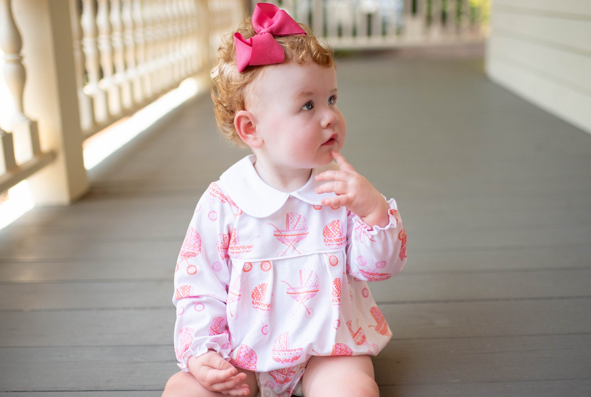 little girl in pink pram long sleeve bubble. Heyward House Bubbles are made with the softest 50/1 interlock pima