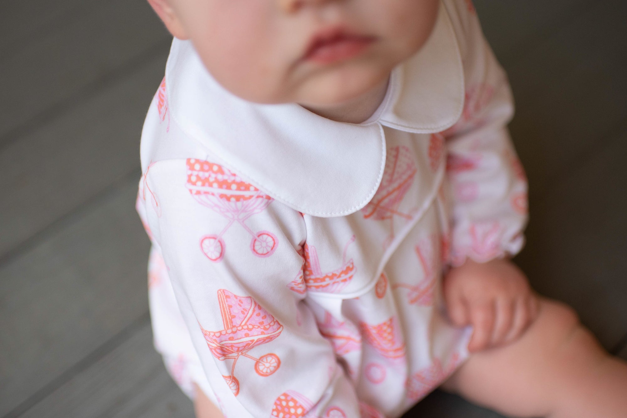 little girl  close up of product in pink pram long sleeve bubble. Heyward House Bubbles are made with the softest 50/1 interlock pima