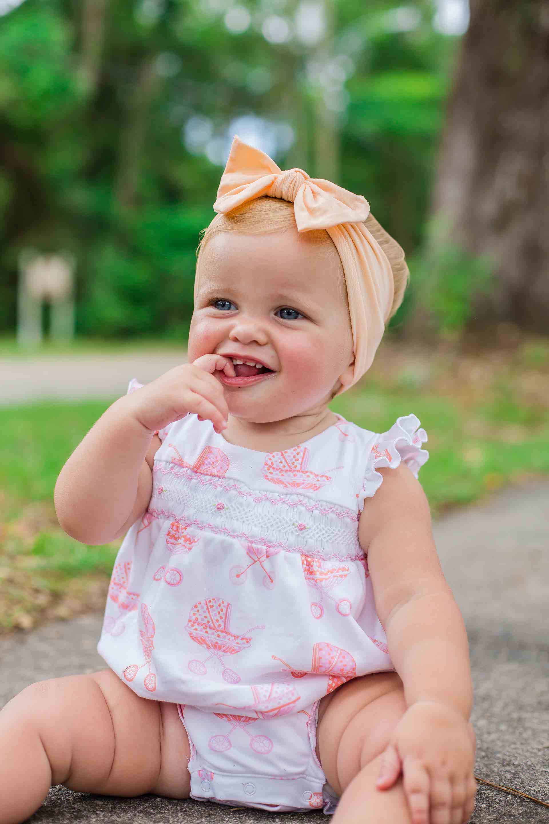 cute baby girl wearing smocked bubble with vintage pram pattern