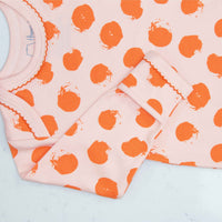 Pink gown with orange polka dot pattern with scratch preventer detail view