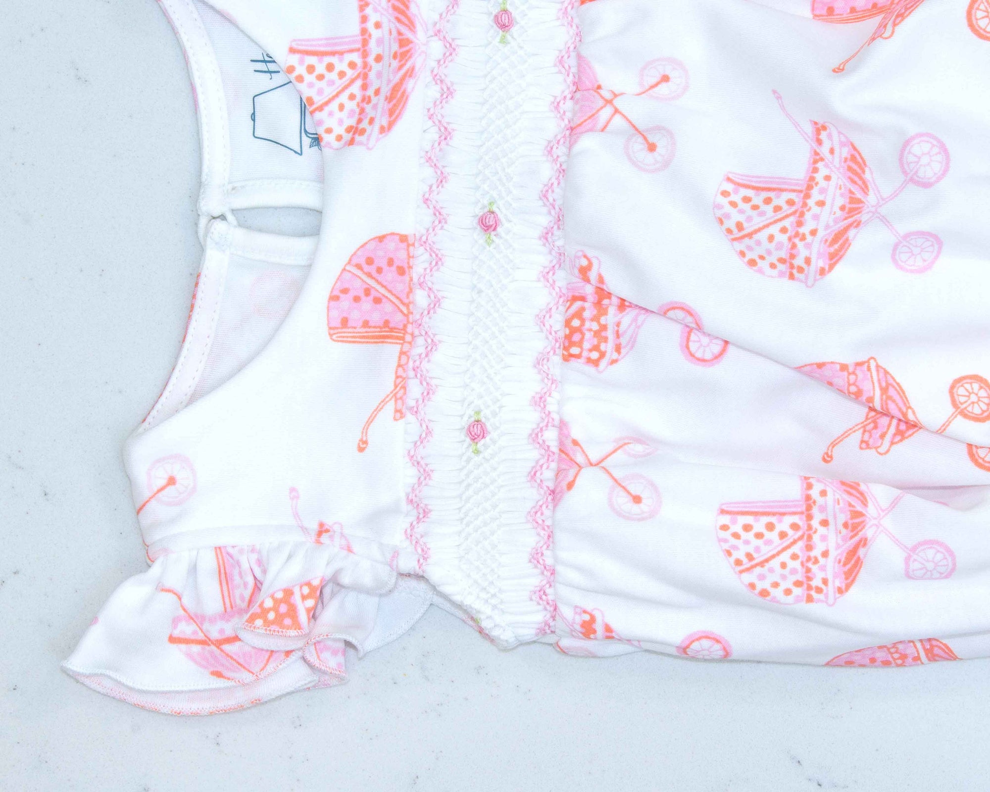 detailed view white girls bubble with smock and vintage-inspired baby carriage pattern made in pima cotton