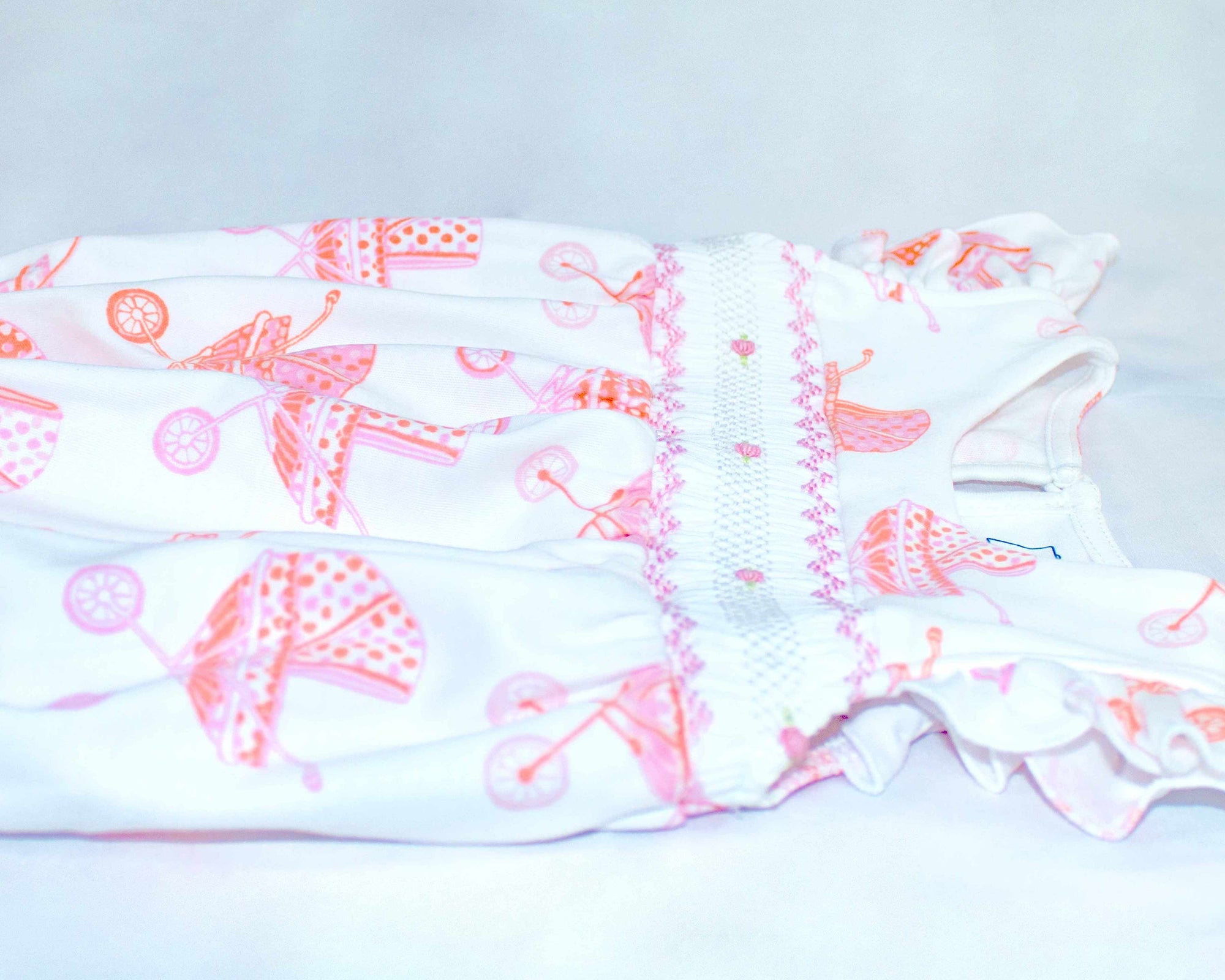 another detailed view white girls bubble with smock and vintage-inspired baby carriage pattern made in pima cotton
